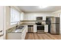 Renovated kitchen with granite countertops and stainless steel appliances at 2363 Dabney Ter, Atlanta, GA 30344