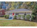 Newly renovated gray brick house with red door and curb appeal at 2415 Plantation Dr, Atlanta, GA 30344