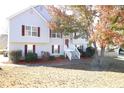 Two-story house with gray siding, white stairs, and landscaping at 6298 Hampstead Ln, Douglasville, GA 30134