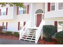 Two-story house entrance with gray siding and white stairs at 6298 Hampstead Ln, Douglasville, GA 30134