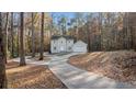 Two-story house with a long driveway, surrounded by trees with fall foliage at 1238 Sandy Creek Rd, Fayetteville, GA 30214