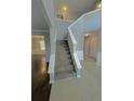 Two-story foyer with a grand staircase and tile flooring at 2897 Hutchins Walk Ct, Snellville, GA 30078