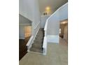 Two-story foyer with a grand staircase and tile flooring at 2897 Hutchins Walk Ct, Snellville, GA 30078