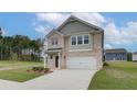 Two-story brick home with a two-car garage, and a neatly landscaped yard at 75 Barge Ln, Covington, GA 30016