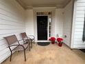 Front porch with two chairs and potted plants at 325 Ridgewood Trl, Canton, GA 30115