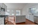 Bright kitchen with island, hardwood floors, and access to backyard at 1987 Ridge Water Ln, Lawrenceville, GA 30045