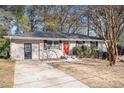Newly renovated ranch home with a red door and long driveway at 763 Tara Se Cir, Atlanta, GA 30354