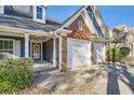 Two-story home with a two-car garage, brick and siding exterior and landscaping at 1756 Hedington Ct, Lawrenceville, GA 30045