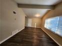 Spacious living room featuring dark brown wood-look vinyl flooring at 4404 Mercer Rd, Decatur, GA 30035