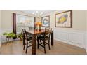 Bright dining room featuring a wood table and wainscoting at 2741 Sedgeview Ne Ln, Buford, GA 30519