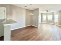 Bright dining area with hardwood floors and view into living room at 6155 Capitol Knoll, Fairburn, GA 30213