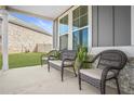 Front porch with three wicker chairs and plants at 1049 Bodega Loop, Locust Grove, GA 30248