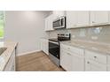Kitchen boasts granite countertops and stainless steel appliances at 7037 Brushwood Bend, Lithonia, GA 30058