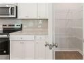 White cabinets, granite countertops, and a large pantry at 7037 Brushwood Bend, Lithonia, GA 30058