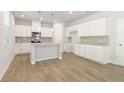Spacious kitchen with white cabinets, granite countertops, and stainless steel appliances at 7037 Brushwood Bend, Lithonia, GA 30058