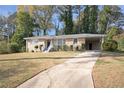 Ranch home with a long driveway and mature trees at 2493 Miriam Ln, Decatur, GA 30032