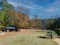 Landscaped backyard with stone gazebo and pond view at 595 S Mount Carmel Rd, Mcdonough, GA 30253