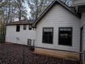 Rear view of a house showing white siding and a chain link fence at 3288 Tarragon Dr, Decatur, GA 30034