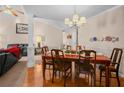 Dining area with hardwood floors, wooden table, and decorative chandelier at 3851 Village Main St, Loganville, GA 30052