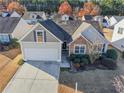 Charming two-story home with attached garage and landscaped front yard at 3851 Village Main St, Loganville, GA 30052