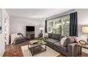 Cozy living room featuring a gray sofa, wooden coffee table, and hardwood floors at 1717 Woodcliff Ct, Atlanta, GA 30329