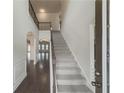 Two-story entryway with hardwood floors and an elegant staircase at 5315 Hopewell Manor Dr, Cumming, GA 30028