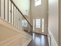Two-story entryway with hardwood floors and an elegant staircase at 5315 Hopewell Manor Dr, Cumming, GA 30028