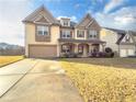 Two-story house with stone accents and a landscaped yard at 5315 Hopewell Manor Dr, Cumming, GA 30028