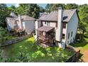 House with backyard, deck, and surrounding houses at 1054 Sunny Field Ln, Lawrenceville, GA 30043