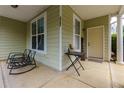 Inviting front porch with rocking chairs and a small table, perfect for relaxing at 4701 Highpoint Ln, Atlanta, GA 30349