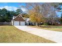 Front view of house with a long driveway and attached garage at 117 Javay Ct, Villa Rica, GA 30180