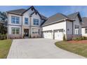 Two-story house with white siding, gray accents, and a three-car garage at 830 Garden Reserve Ln, Alpharetta, GA 30005