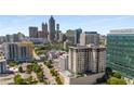Aerial city view, showcasing a modern high-rise building with a rooftop pool at 565 Peachtree Ne St # 1209, Atlanta, GA 30308