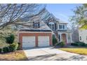 Two-story house with three-car garage and stone accents at 116 Northbrooke Trce, Woodstock, GA 30188