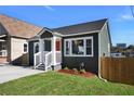 Newly remodeled home with gray siding, a wooden fence, and a neat front yard at 541 Sunset Nw Ave, Atlanta, GA 30318