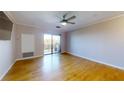 Spacious living room featuring hardwood floors and sliding glass door to balcony at 300 Johnson Ferry Ne Rd # B611, Atlanta, GA 30328