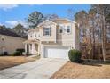 Two-story home with a two-car garage, front porch, and landscaping at 2907 Edgewater St, Atlanta, GA 30331