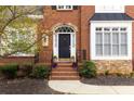 Brick front entry with a black door, stone accents, and landscaping at 2984 Winterthur Close Nw, Kennesaw, GA 30144