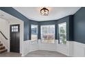 Bright dining room with bay window, dark door, and white wainscoting at 4524 Glider Cir, Douglasville, GA 30135