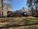 Ranch style brick home with a spacious yard and trees at 1200 Lakewood Ne Dr, Conyers, GA 30013