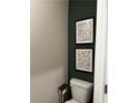 Small bathroom with dark green accent wall and framed art at 107 Meadowview # 23, Temple, GA 30179