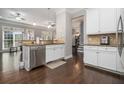 Modern kitchen with white cabinets, stainless steel appliances, and granite countertops at 5453 Battery Ln #20 Ln, Atlanta, GA 30342