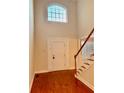 Two-story foyer with hardwood floors, elegant staircase, and a large window at 225 Bayswater Dr, Suwanee, GA 30024