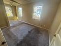 Spacious bedroom with two windows, carpeted floor, and a ceiling fan at 1480 Belmont Sw Ave, Atlanta, GA 30310