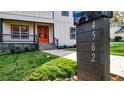 Modern house number marker in front of a two-story home with orange front door at 4562 Spring St, Acworth, GA 30101