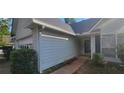 Newly painted house with a walkway leading to the entrance and well-maintained landscaping at 764 Avalon Forest Way, Lawrenceville, GA 30044