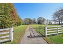 Home with white fence and gated entrance at 14299 Highway 36, Covington, GA 30014