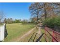Open wrought iron gate leading to property at 14299 Highway 36, Covington, GA 30014