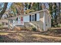 Front view of a brick ranch house with a red door and steps at 1425 Cobb Branch Dr, Decatur, GA 30032