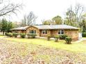 Stone house exterior with landscaping and a detached garage at 3645 Aldea Dr, Decatur, GA 30032